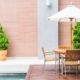 table and chair with white umbrella outdoor patio